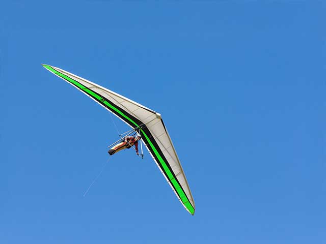 Silhouette of athlete competing in pole vault at dusk
